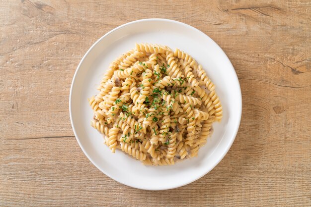 spirali or spiral pasta mushroom cream sauce with parsley - Italian food style