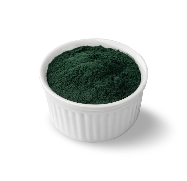 Spirulina algae powder in a bowl isolated over white background