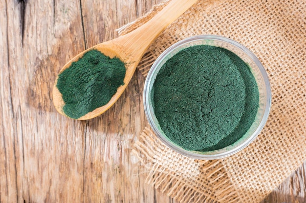 spirulina algae powder in wooden bowl