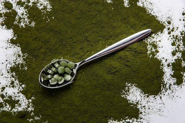 Spirulina is a useful supplement. on a white background