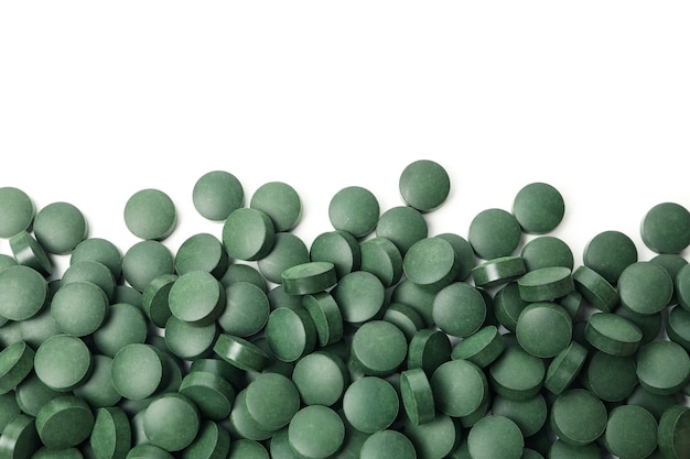 Spirulina in pills isolated on white background