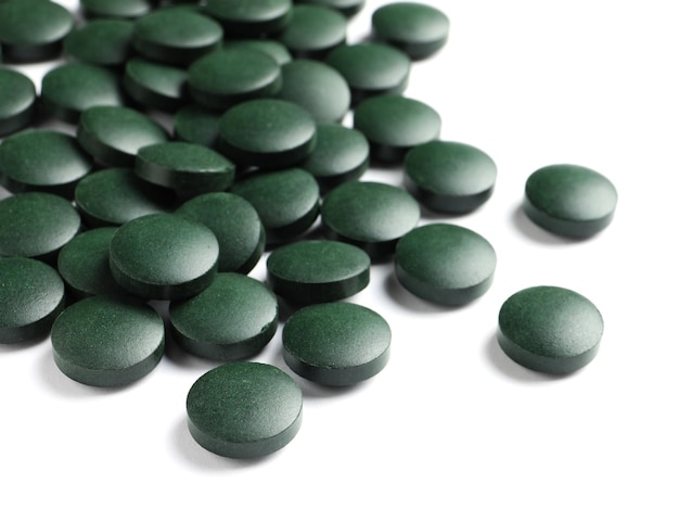 Spirulina tablets on white background Healthy lifestyle