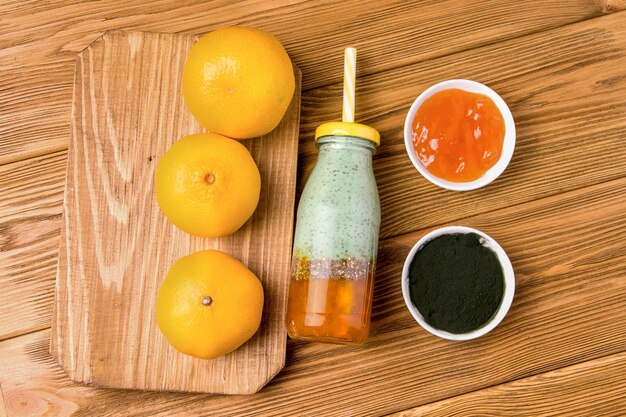 Spirulina, yogurt and citrus jam drink on a wooden background