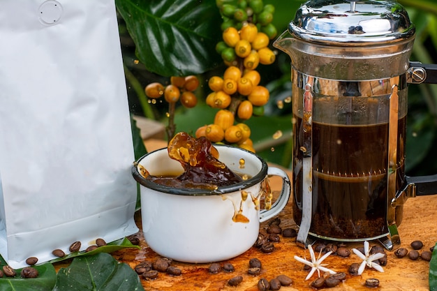 splash coffee cup with french coffee pot with unbranded packing in the forest