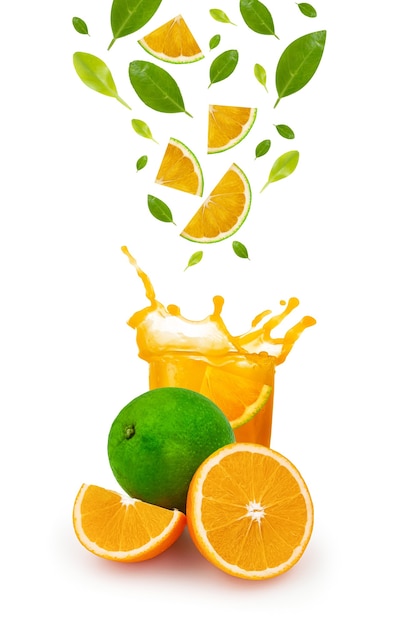 Splash in glass of orange juice with cut oranges isolated on white background