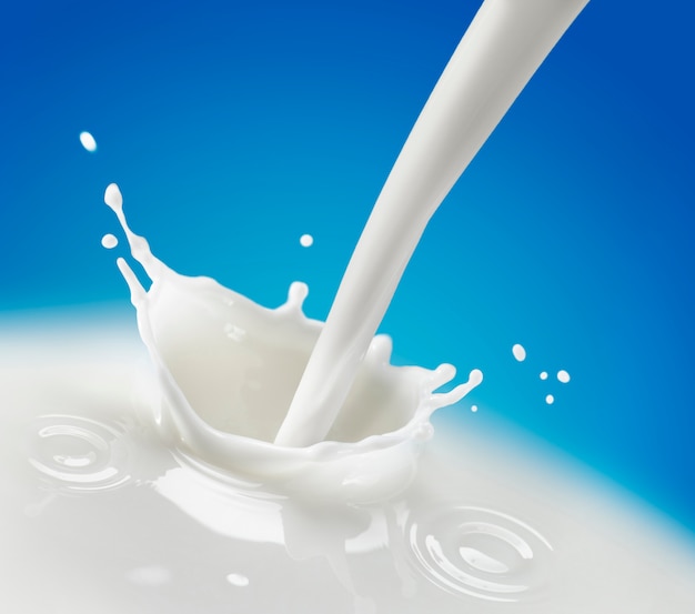 A Splash of Milk over Blue Background