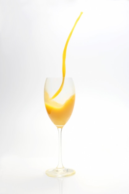 Splash of orange juice in the glass on white
