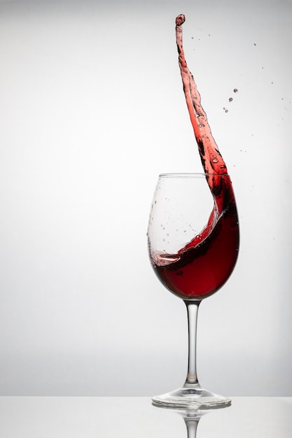 Splash of red wine in a crystal glass