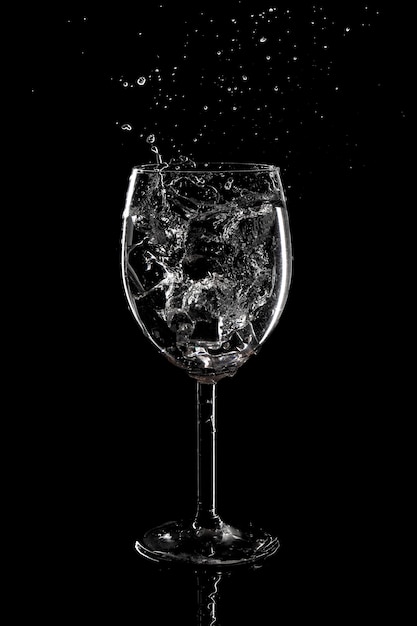 Splash of water in a glass on a black background