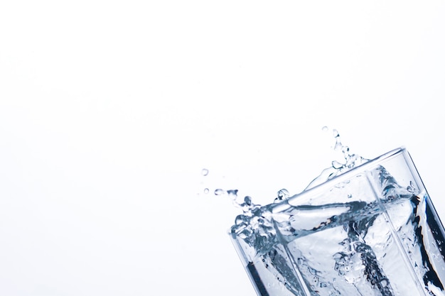 Splash of water in a glass from an ice cube .