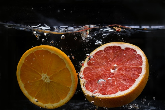 Splash of water with fruits lemon orange