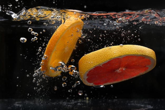 Splash of water with fruits lemon orange