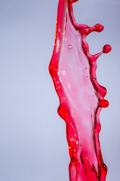 Splashes of red wine on a white background abstraction