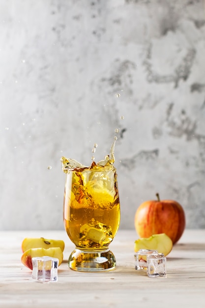 splashing apple juice in a glass