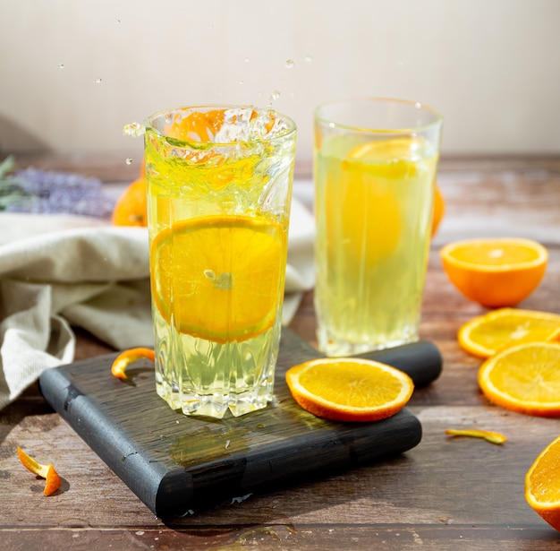 splashing homemade orange juice with slice of orange