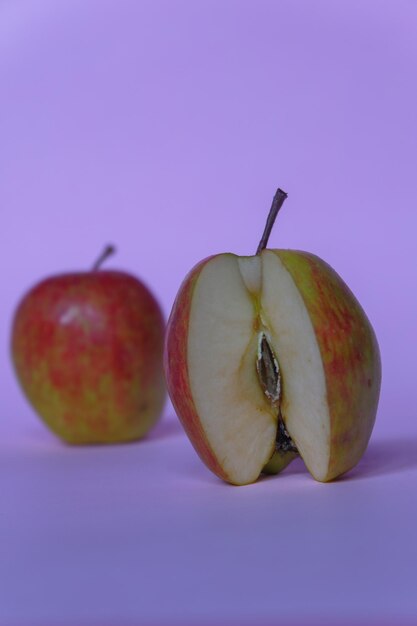 A split apple with a pink background a perfect photo for a food flogger