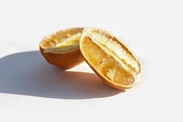 spoiled lemon in a cut on a white background bad products rotten lemon