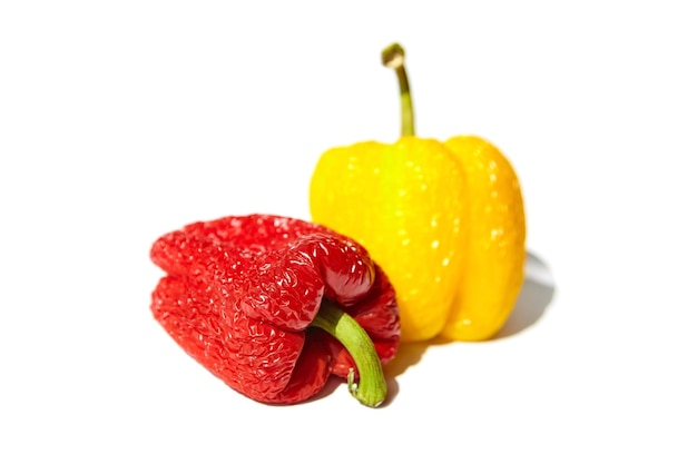 Spoiled wrinkled red and yellow peppers isolated on white background