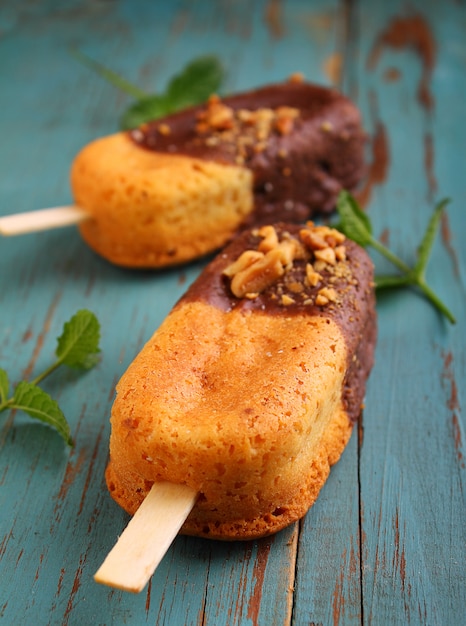 Sponge cake in a black plate decorated with mint