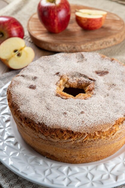 Sponge cake or chiffon cake with apples so soft and delicious sliced with ingredients cinnamon eggs flour apples on wooden table Home bakery concept for background and wallpaper