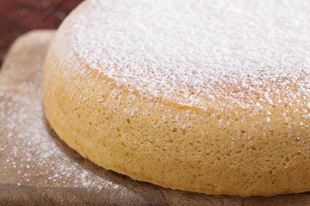 Sponge cake on old wooden table