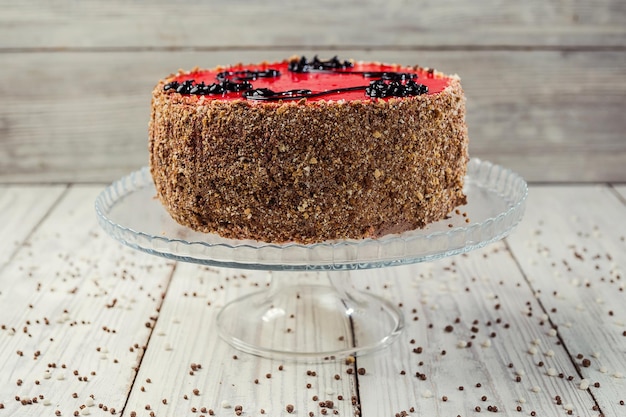 Sponge cake with fruit jelly on wooden background