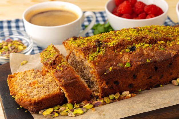 Sponge cake with pistachio on wooden board