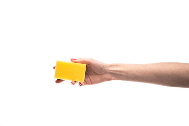 Sponge in female hand with red nails isolated on a white background