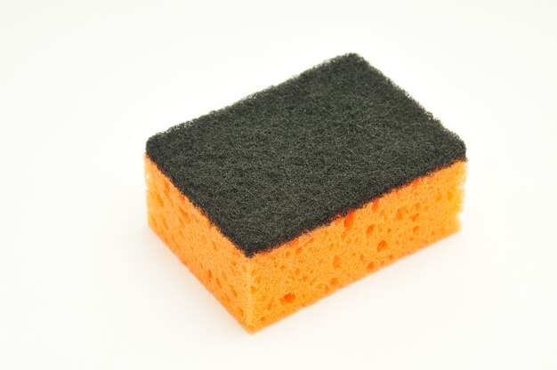 Sponge for washing dishes and plumbing on an isolated white background