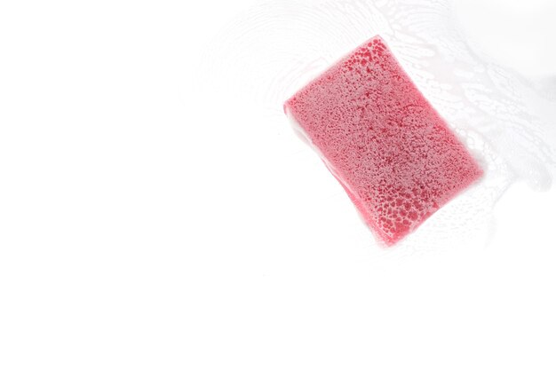 Sponge for washing dishes on transparent glass with foam