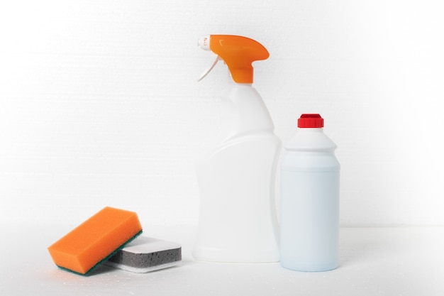 Photo sponges and cleaning agents on white background