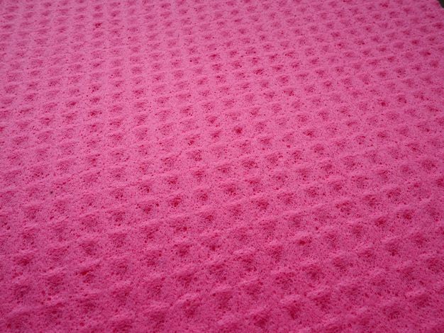 Spons vezels spons textuur patroon oppervlakte close-up roze magenta achtergrond