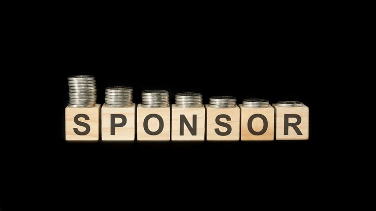 Sponsor word of wooden blocks with letters on a black background selective focus
