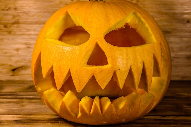 Spooky halloween pumpkin on rustic wooden table