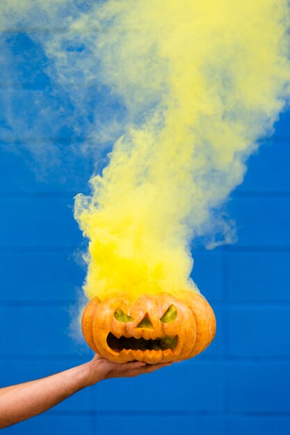 Spooky Halloween pumpkin With yellow Smoke