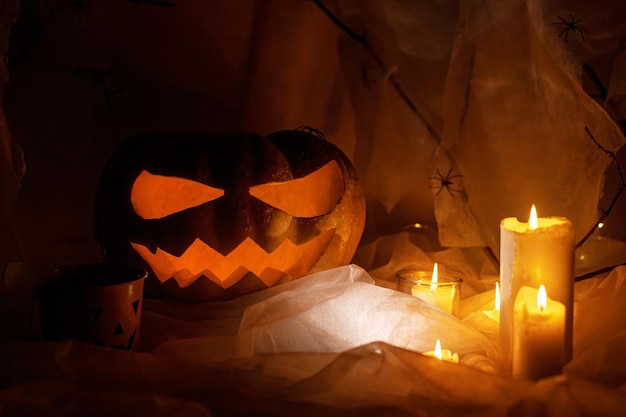 Spooky Jack o lantern gesneden pompoen spinnenweb spookspinnen en gloeiend licht in het donker Happy Halloween Scary sfeervolle halloween feestdecoraties ruimte voor tekst Trick or treat