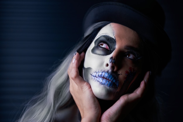 Spooky portrait of woman in halloween gothic makeup