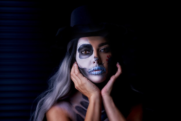 Spooky portrait of woman in halloween gothic makeup