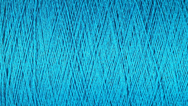 Spool of blue thread macro background texture