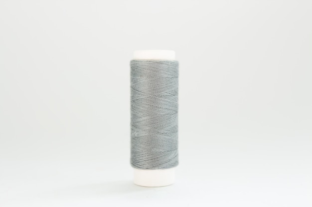 Spool of gray thread on a white background