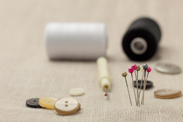 Photo spool of thread and needles for sewing closeup