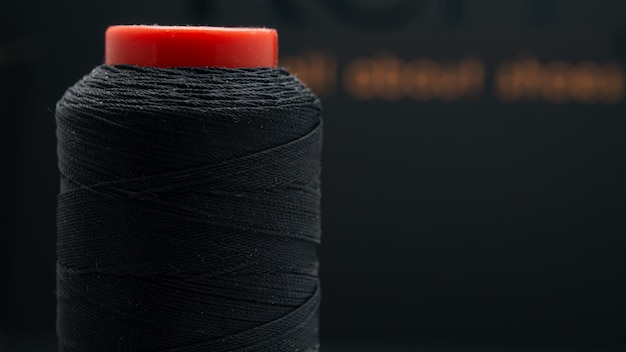 spool with black threads close-up