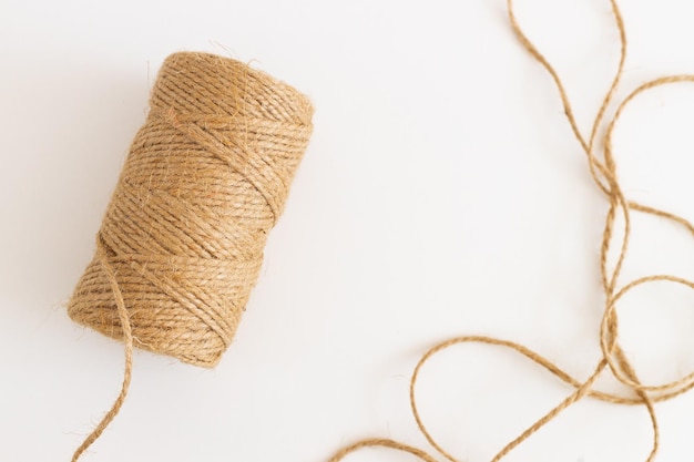 Spool with twine on white table