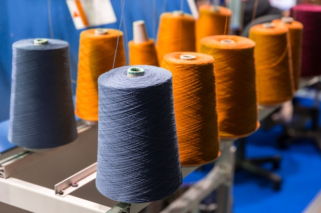 Spools of color threads closeup, sewing equipment