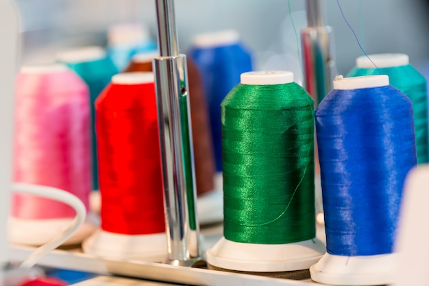 Spools of color threads closeup, sewing material