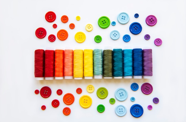 Spools of thread and buttons on the colors  of the rainbows