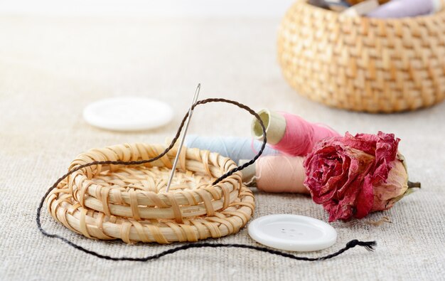 Spools of thread with needle and sewing buttons