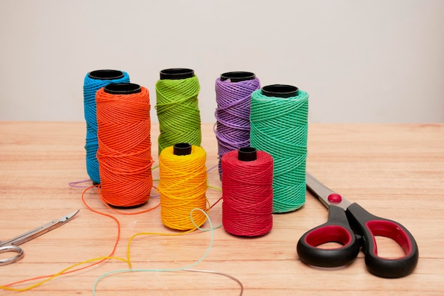 Spools of threads of different colors and scissors