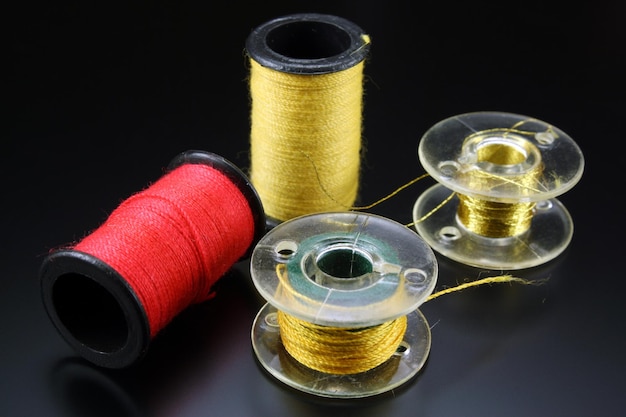 Spools with sewing threads on black