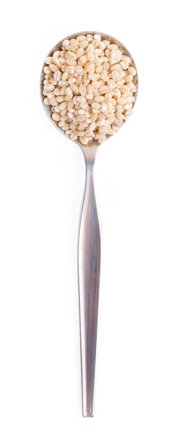 Photo spoon of barley rice isolated on white background